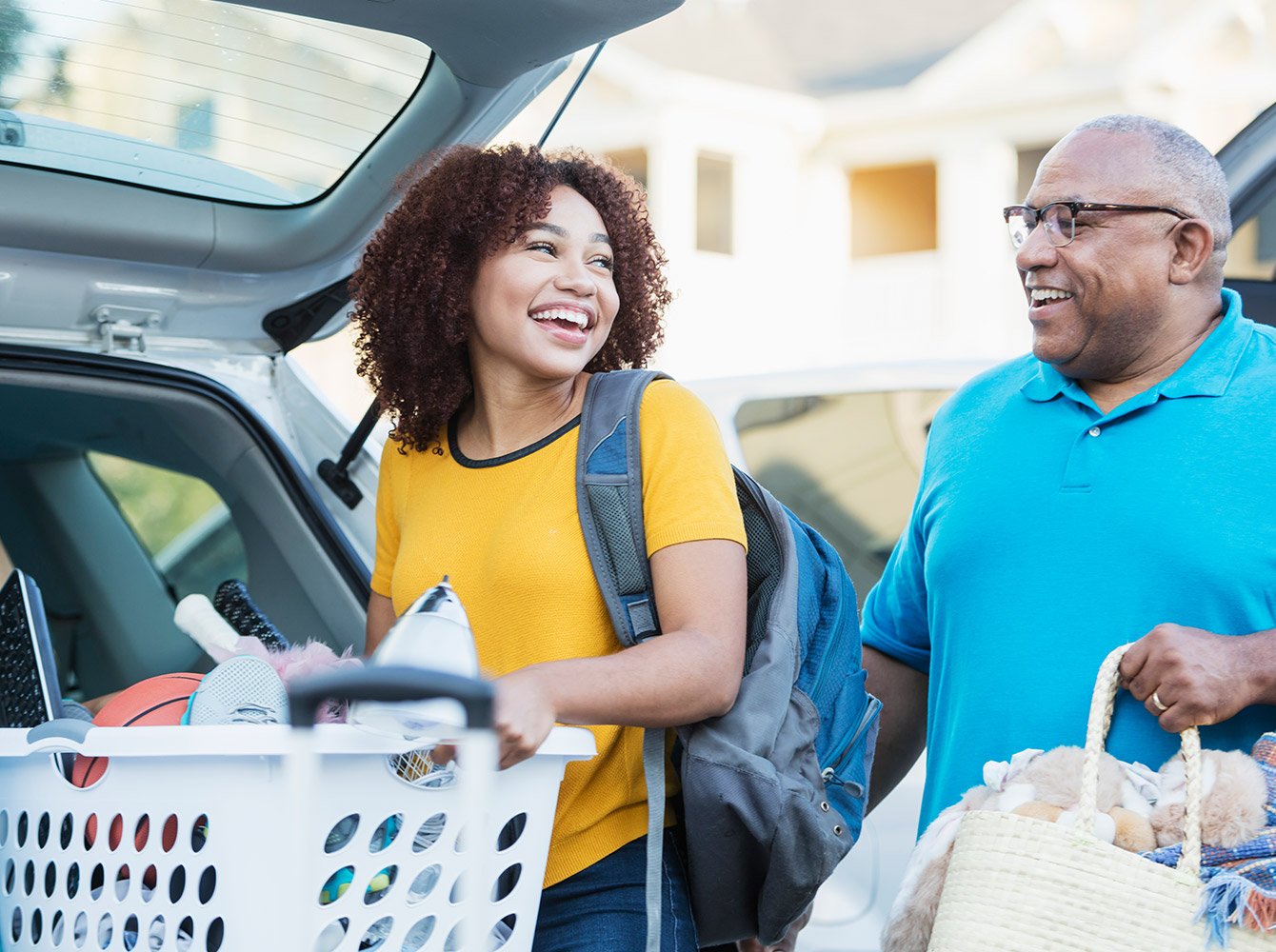A college student and their parent packing the car to go to college