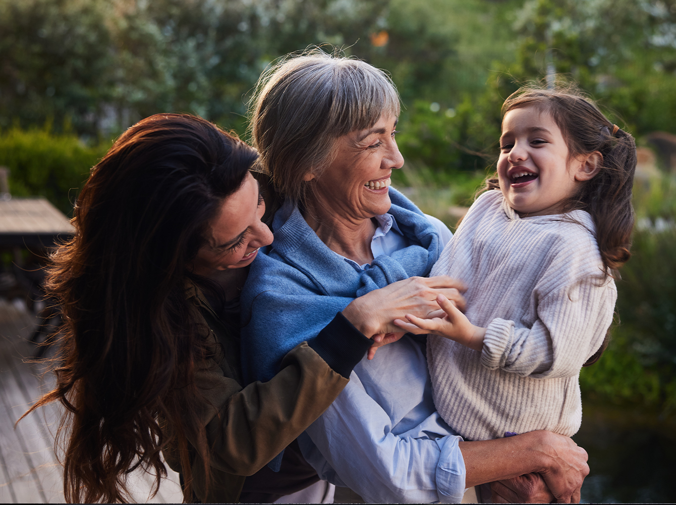 Two women holding a little girl