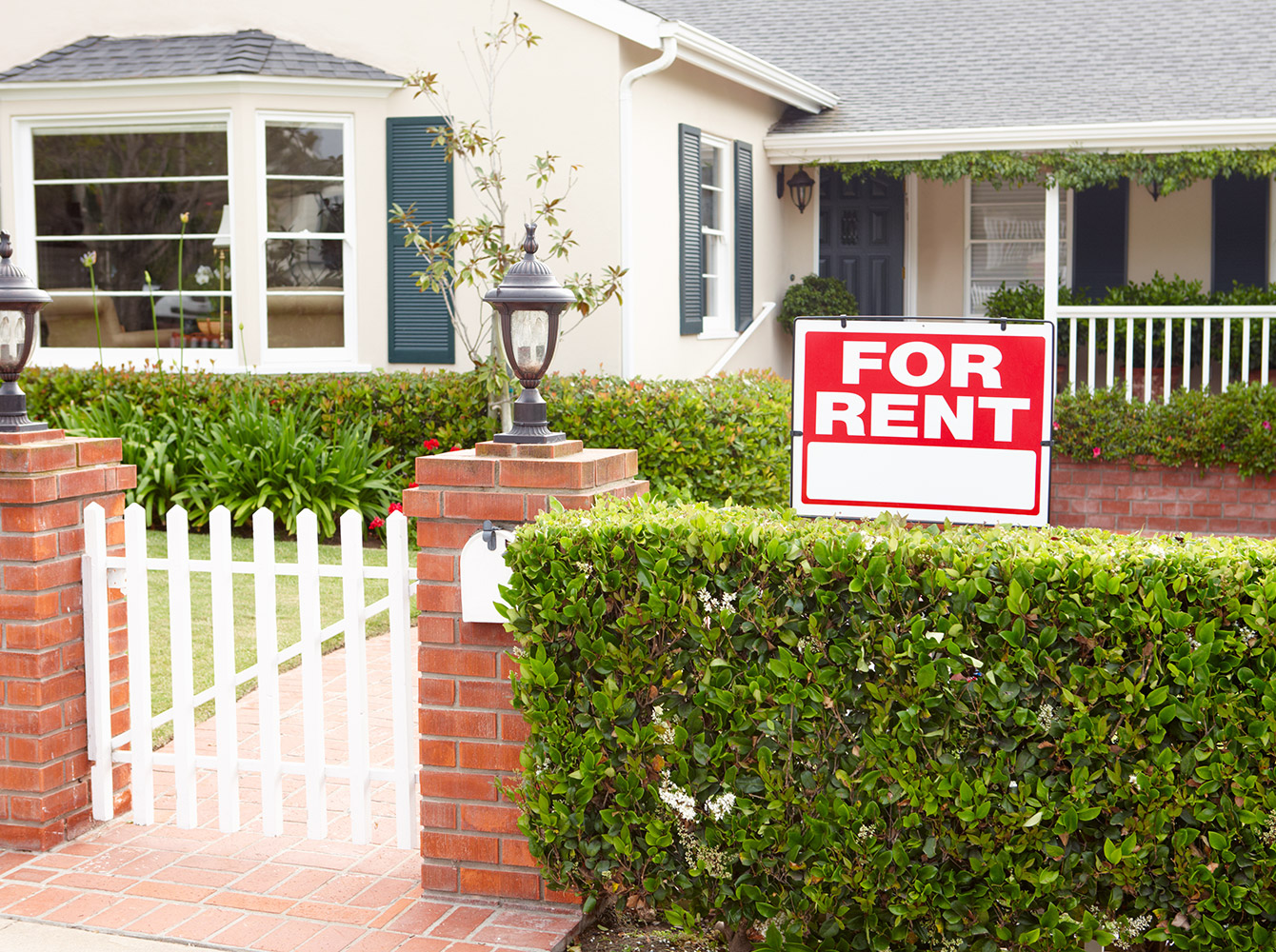 A house with a for sale sign in the front yard.