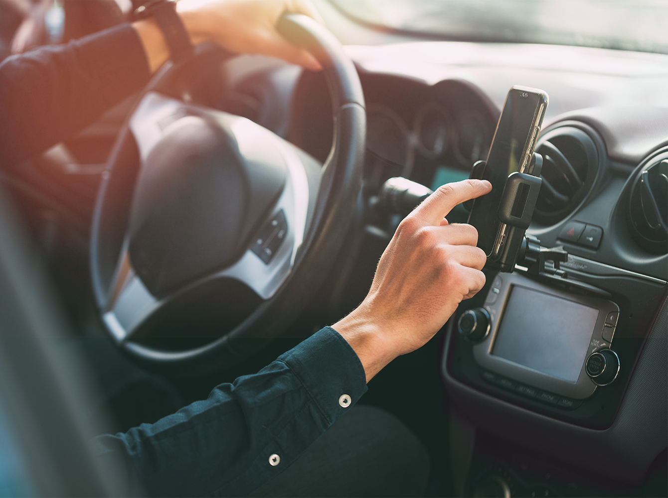 A close up of a person driving a car.