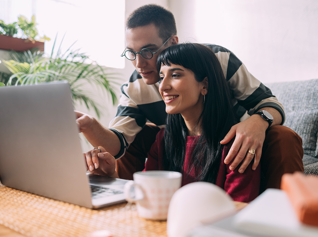 A couple is looking at a laptop together.