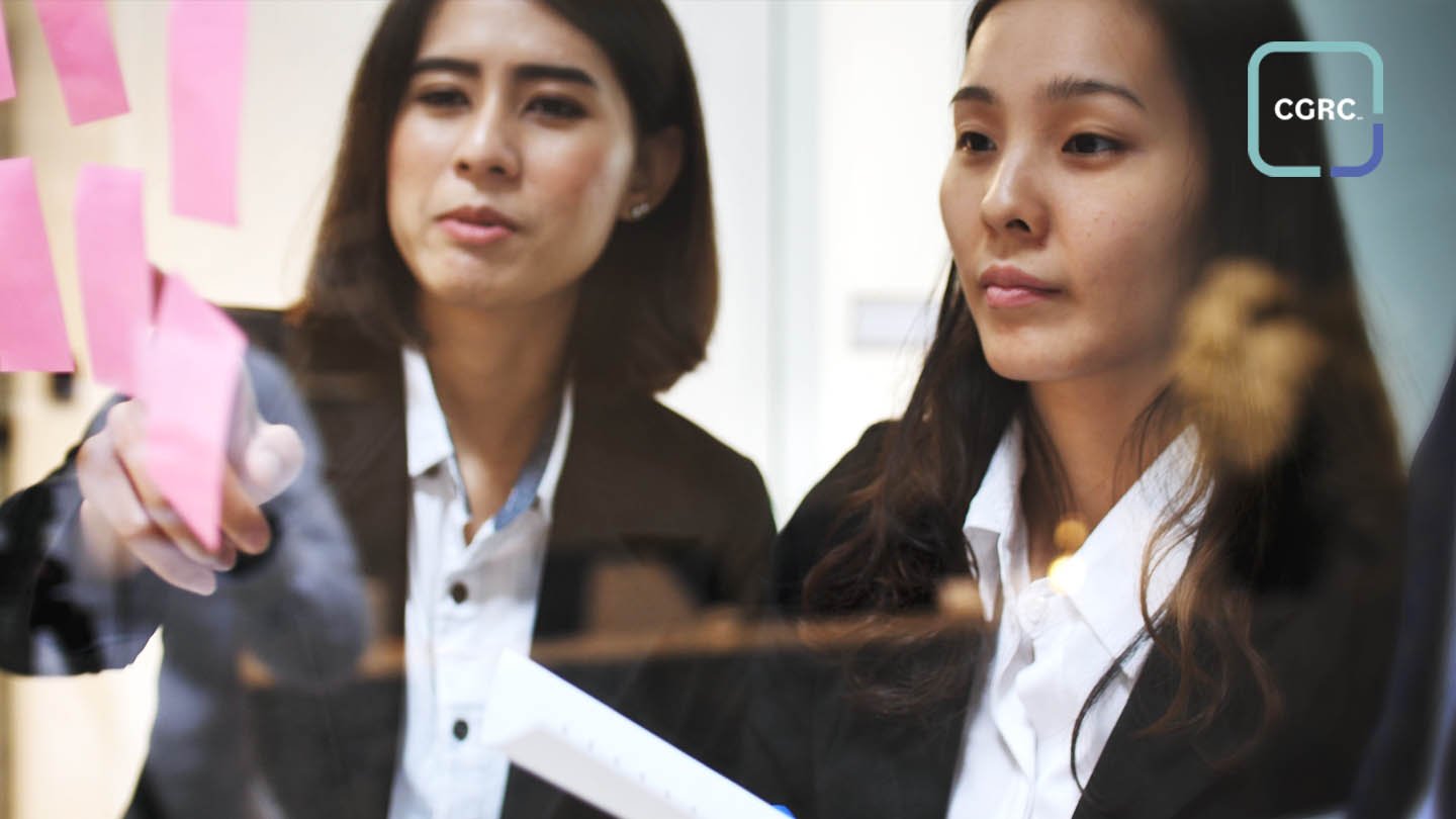 Two women looking at post it notes