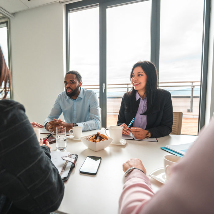 Four people meeting in a conference room