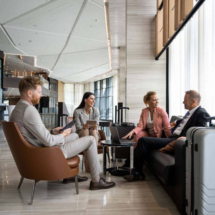 Four people meeting in a hotel lobby