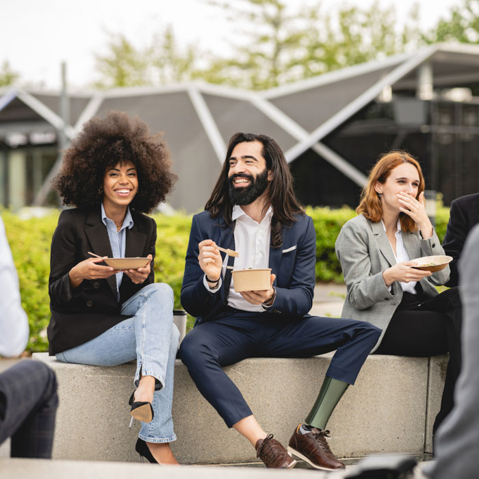 A group of smiling business people outside