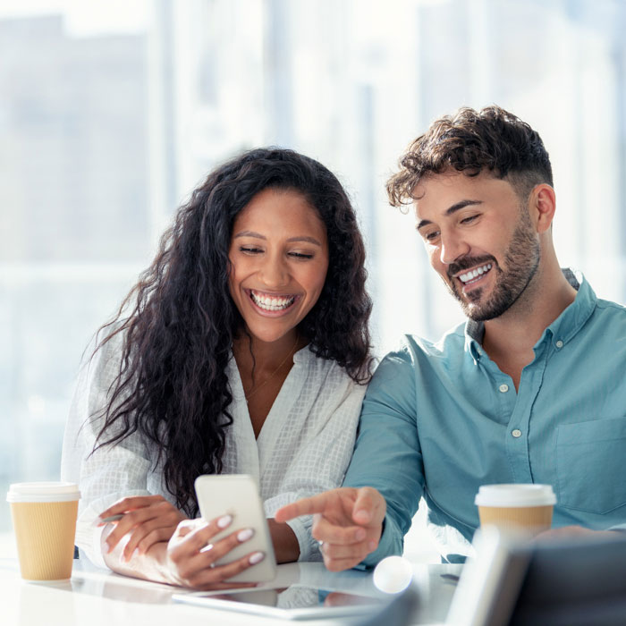 Two people smilng at a phone