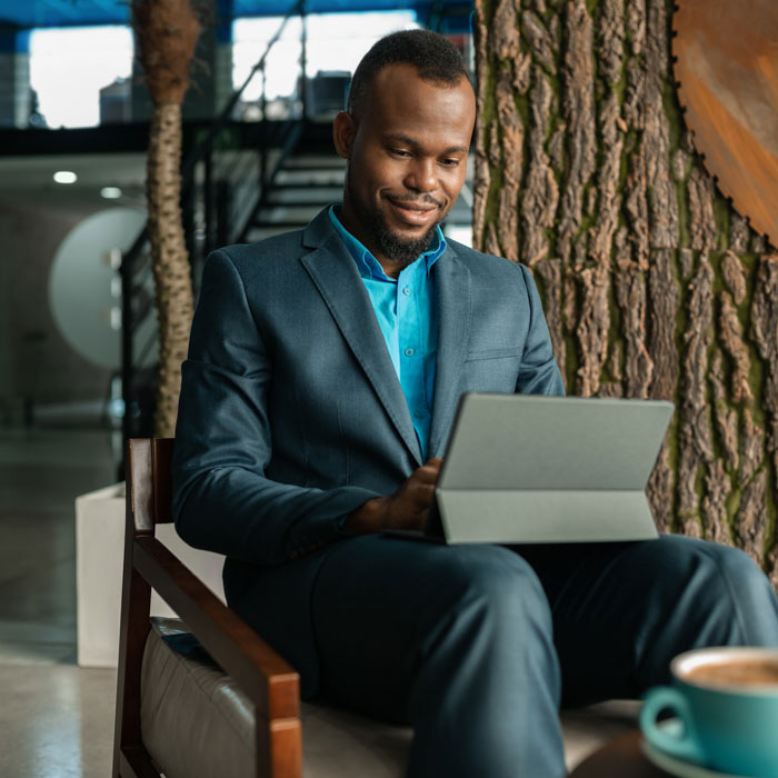 A business man using a tablet inside a coffee shop