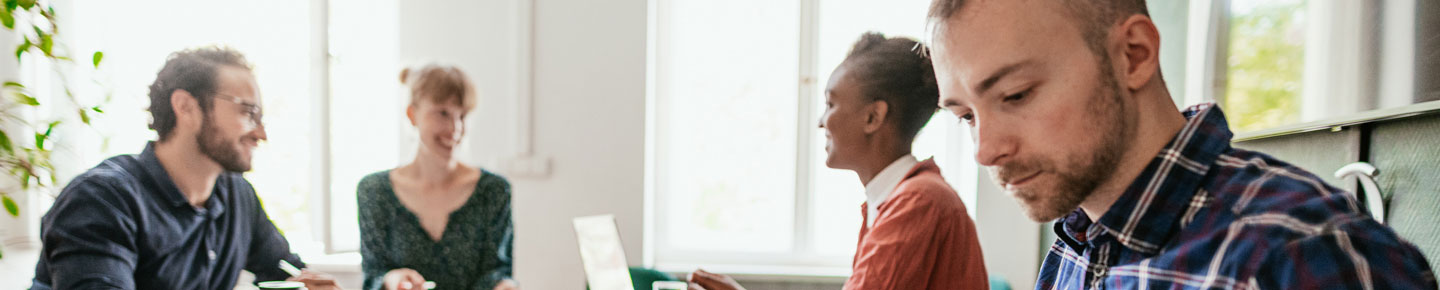Four people meeting in a modern office