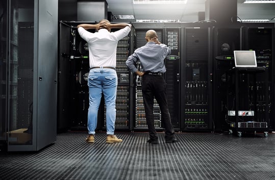 Men looking at servers in defeat