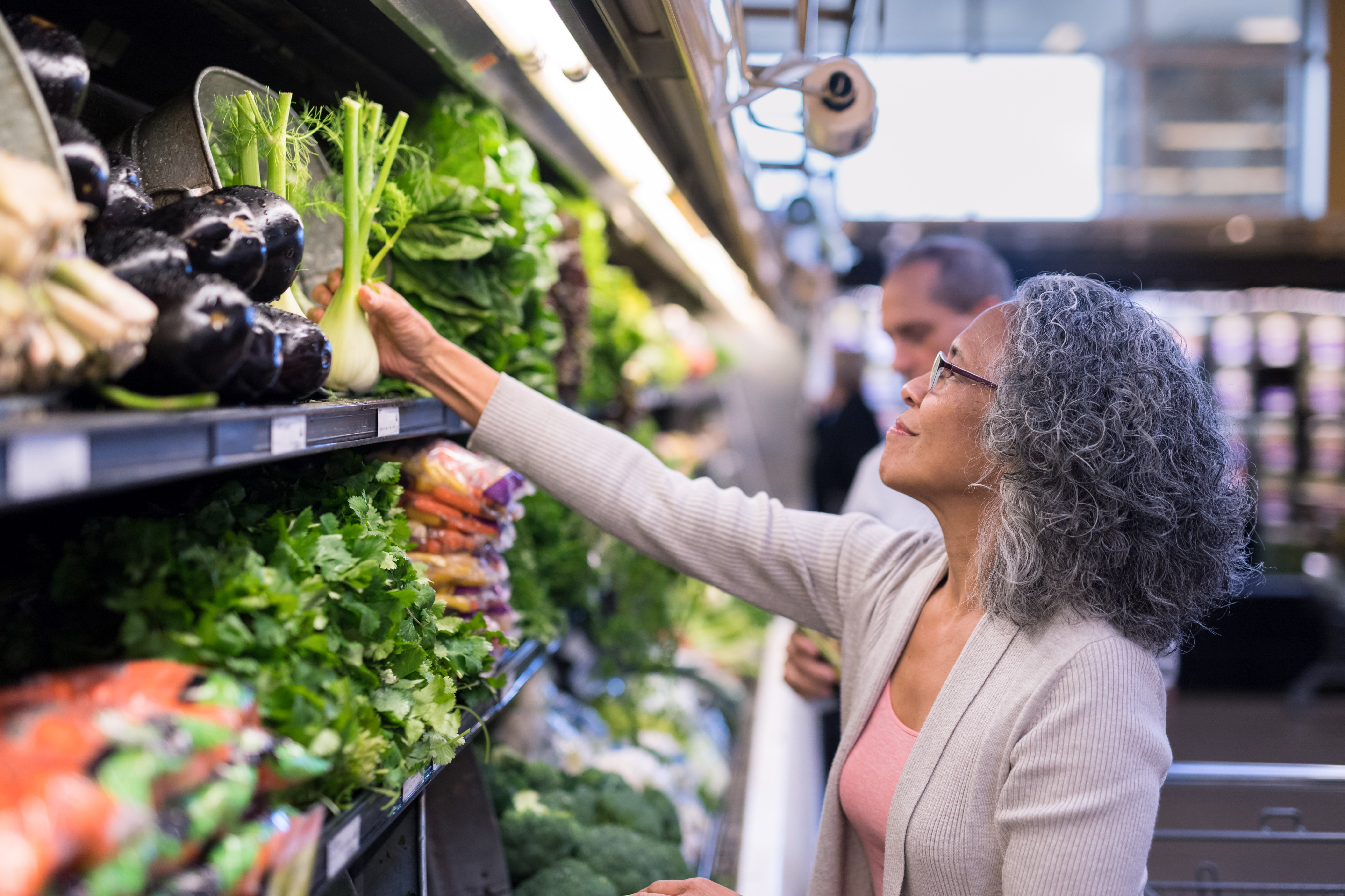 Woman selecting produce at market