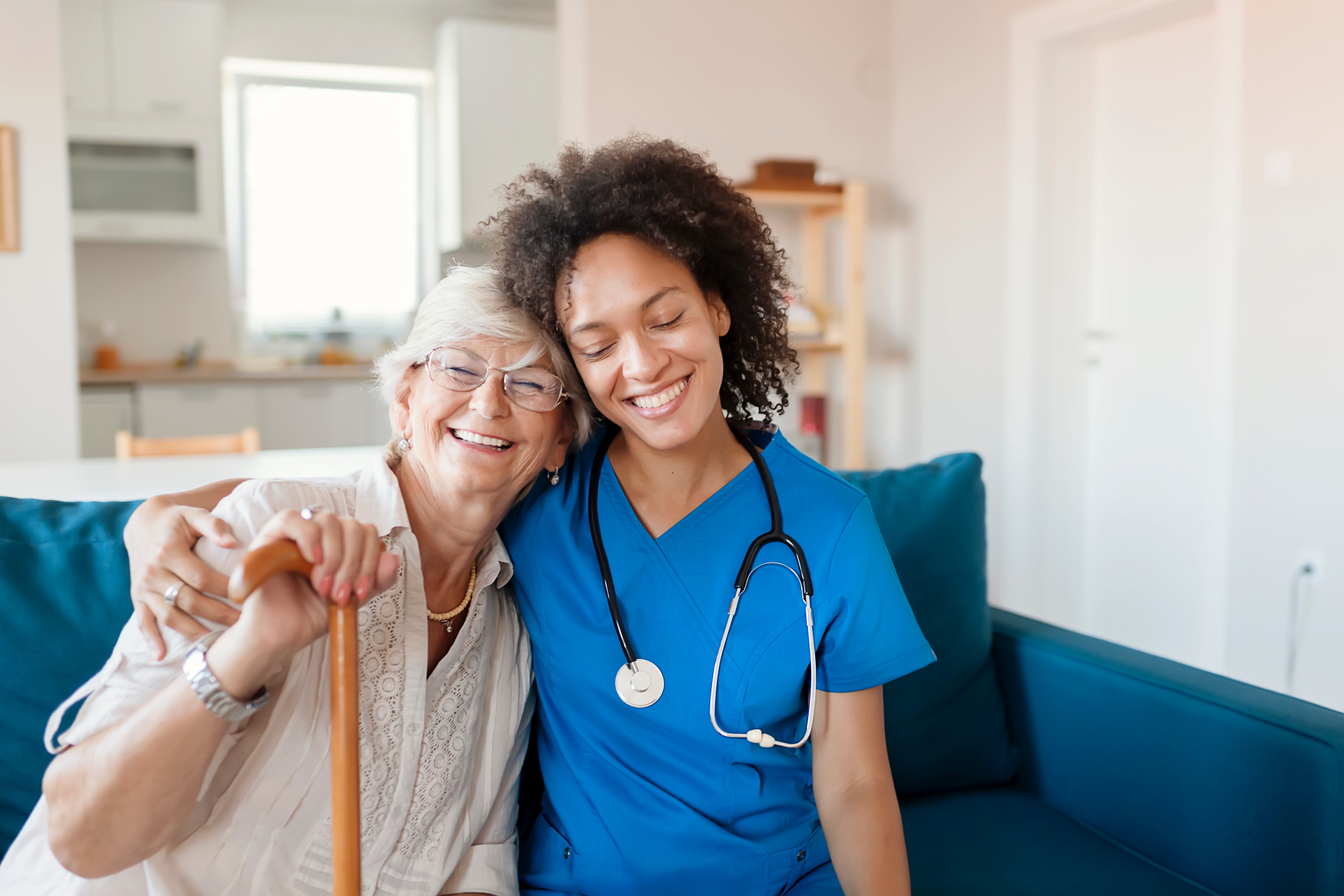 woman doctor with woman patient hugging