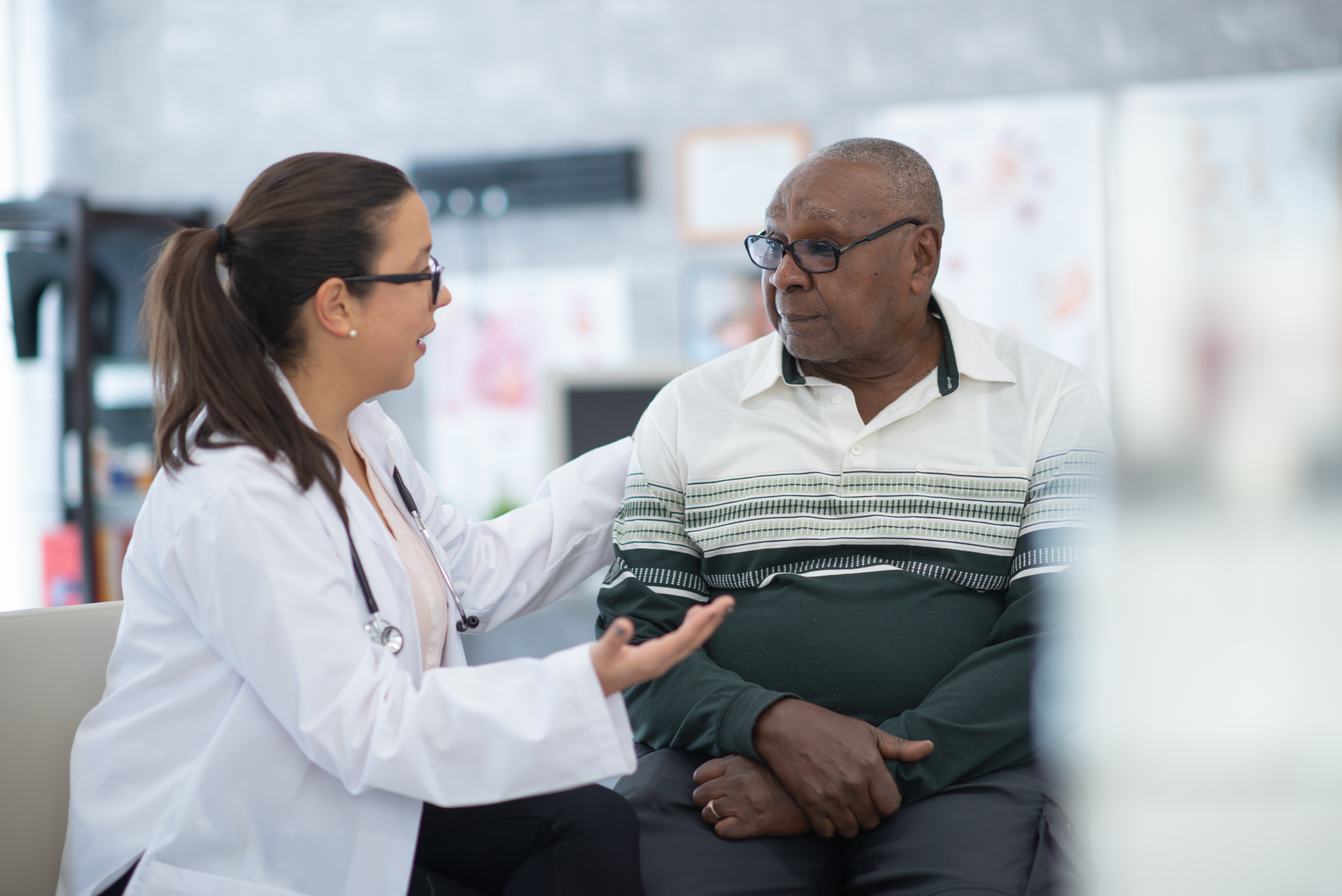 Side view of woman doctor with male patient