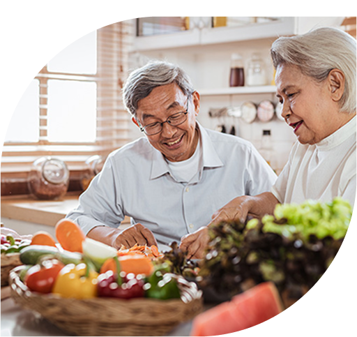 Senior Asian couple cooking together in kitchen