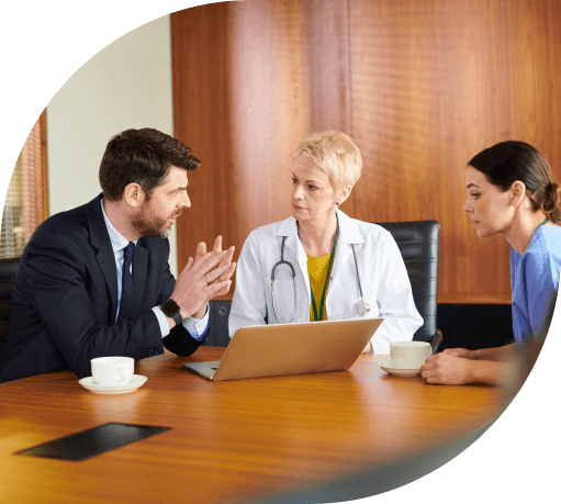 Female doctor and nurse meet with administrator