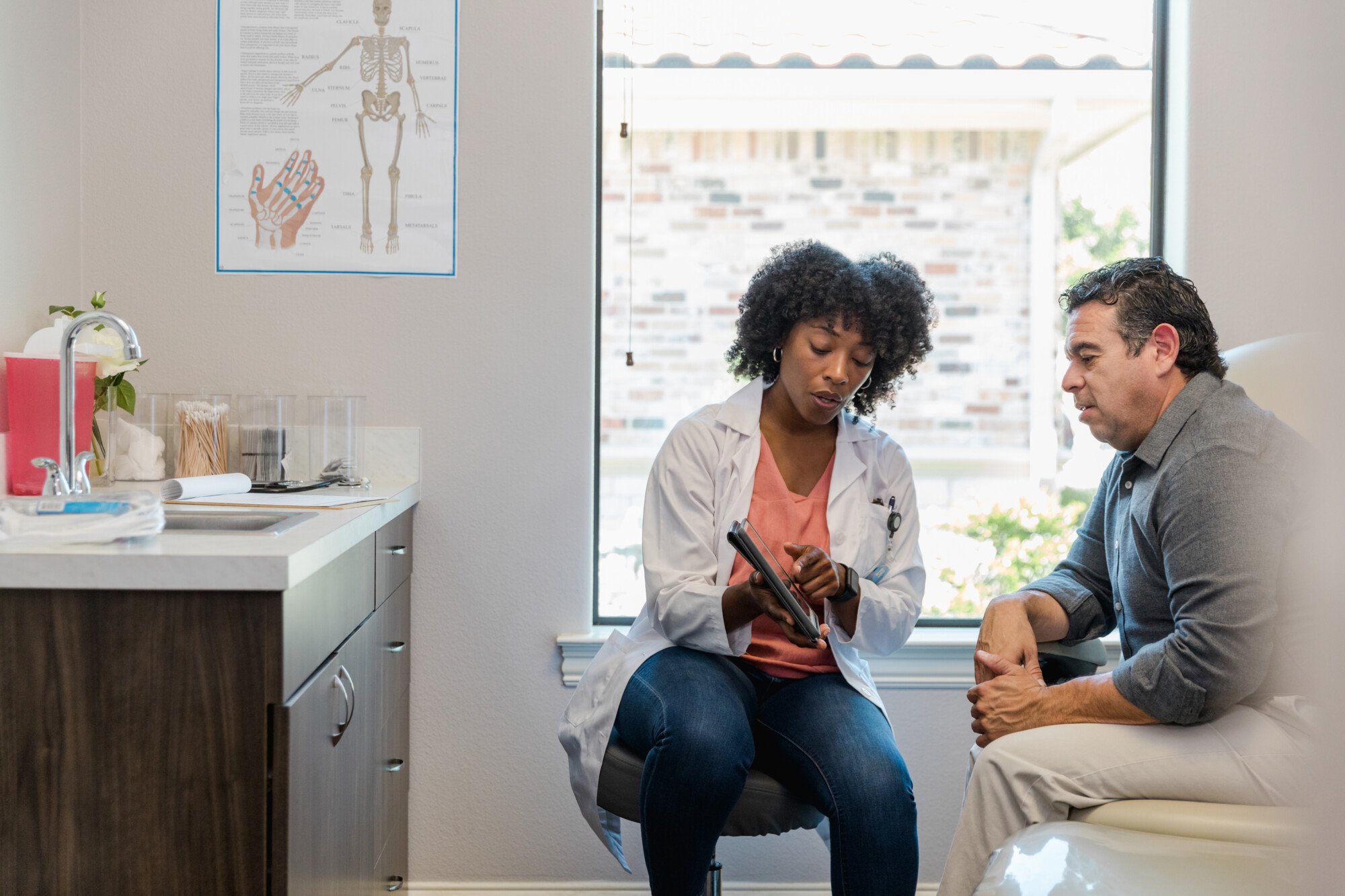 Doctor shows patient results in a room