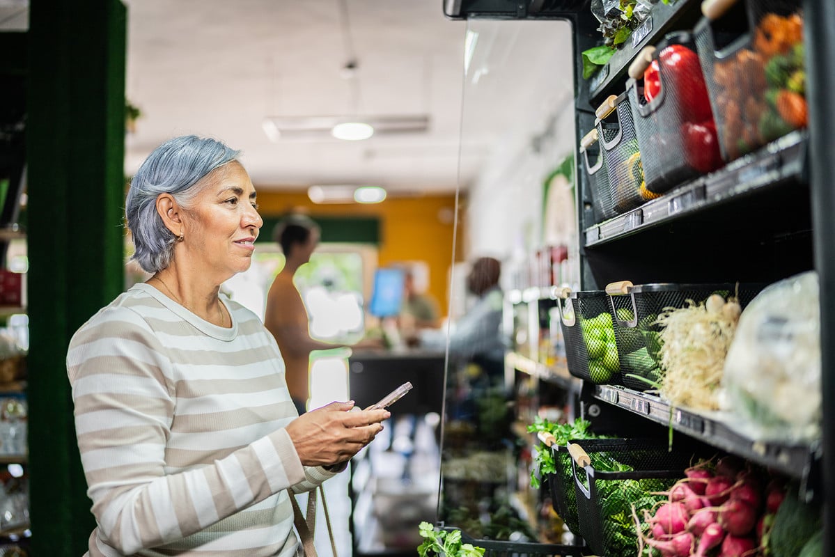Woman shopping at the grocery store with list in hand