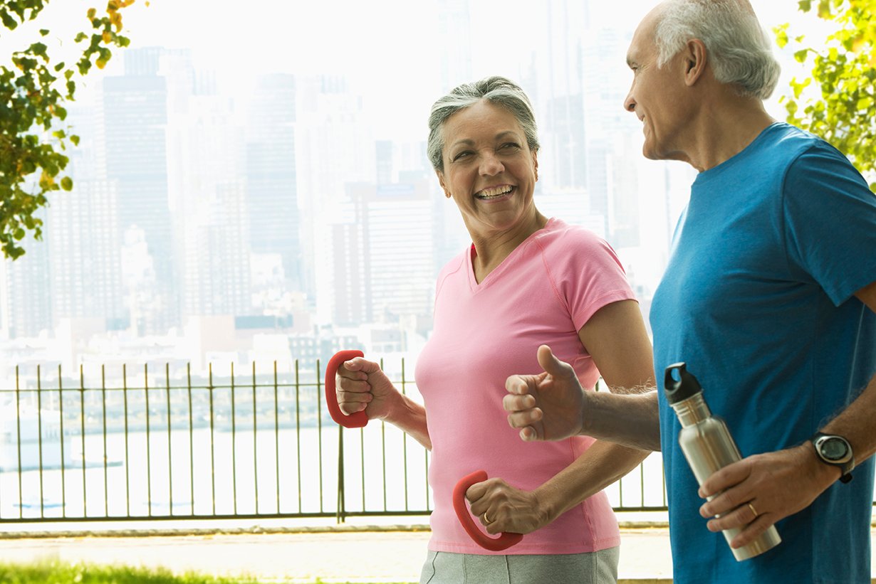 Woman and man walking in the park with weights