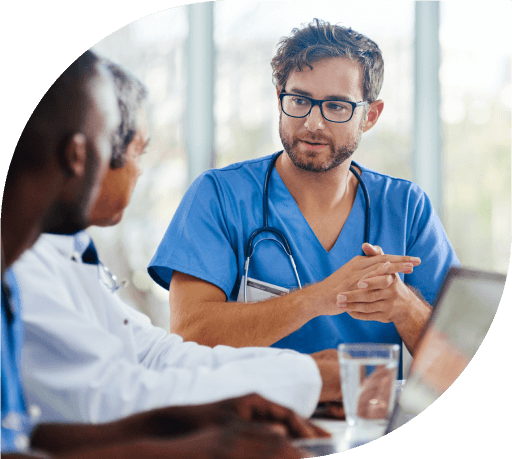 Doctors and nurses talking at a table