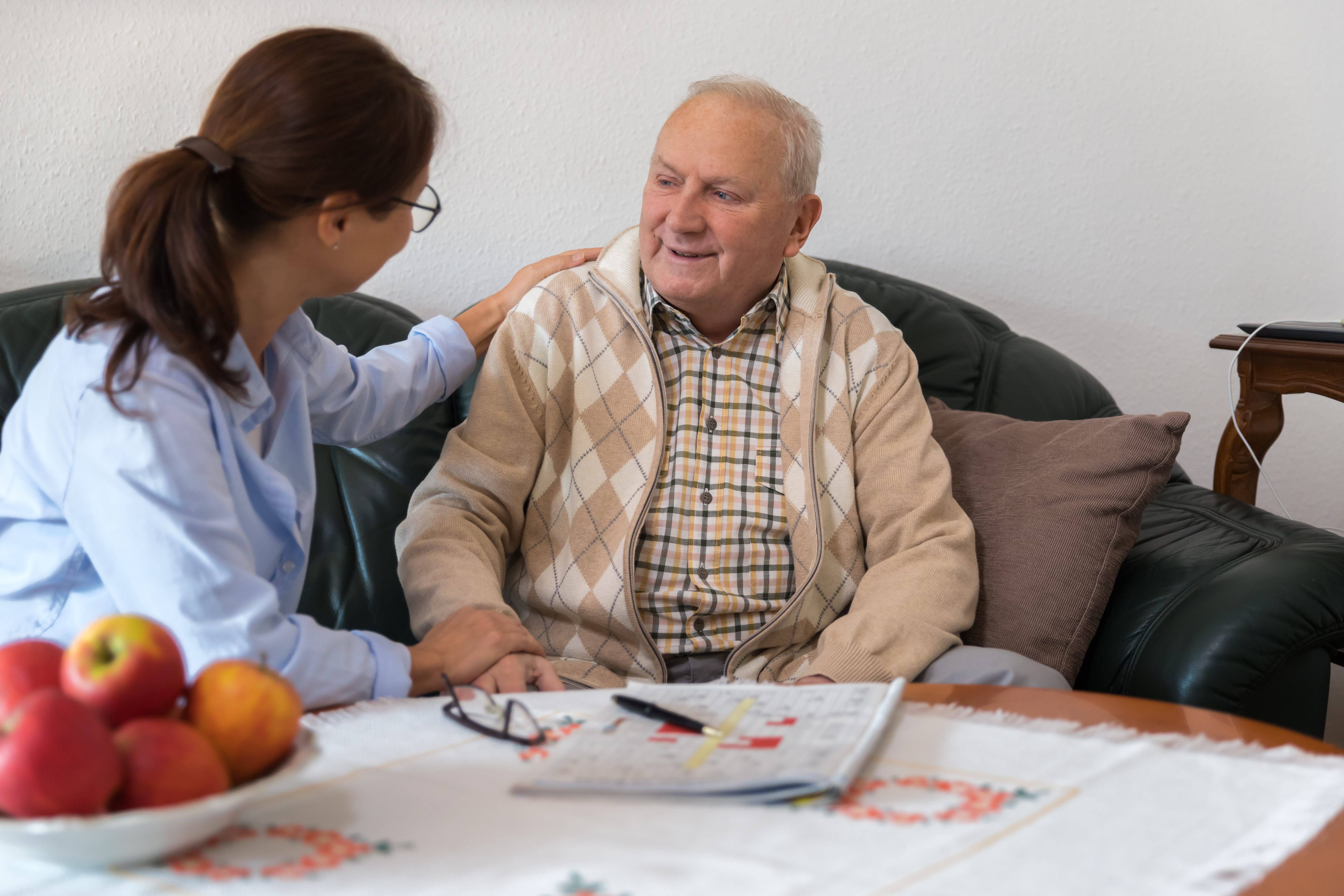 Caring Nurse speaks with Elderly Patient