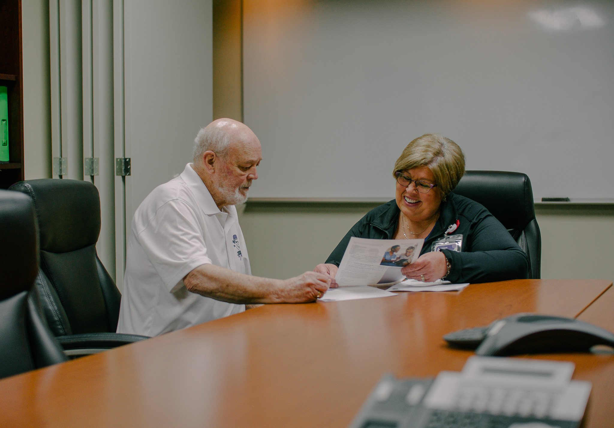 Interwell Health RCC Kathy Galloway reviews educational materials with an Interwell 360 patient