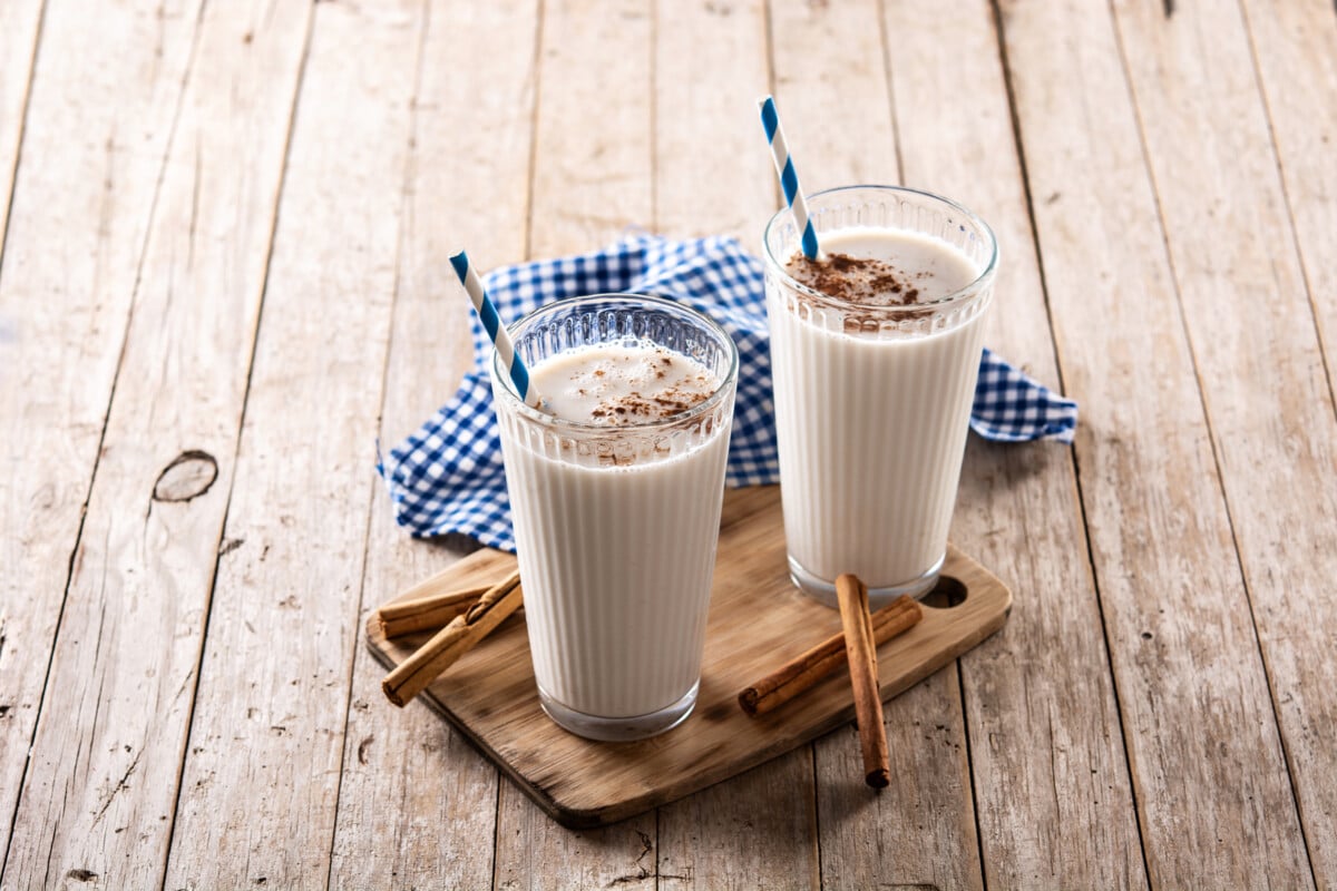 Fresh horchata with cinnamon in glass on rustic wooden table