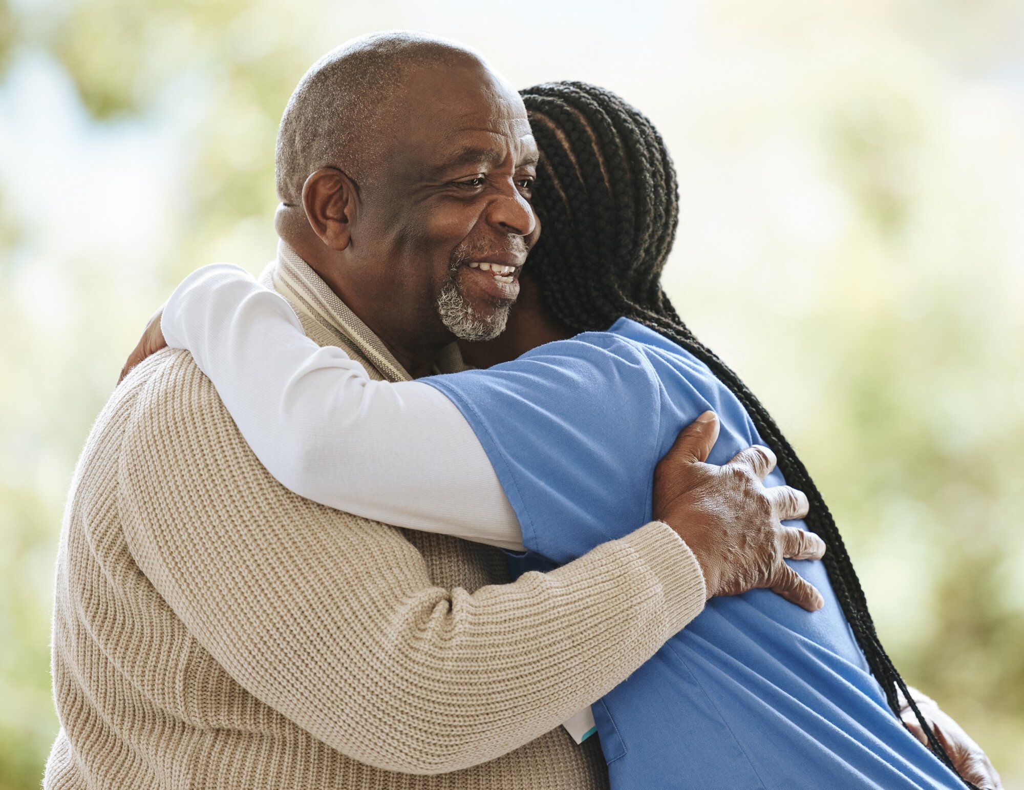 Nurse hugs older patient