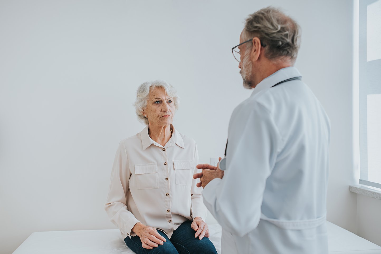 Senior woman consulting with male physician