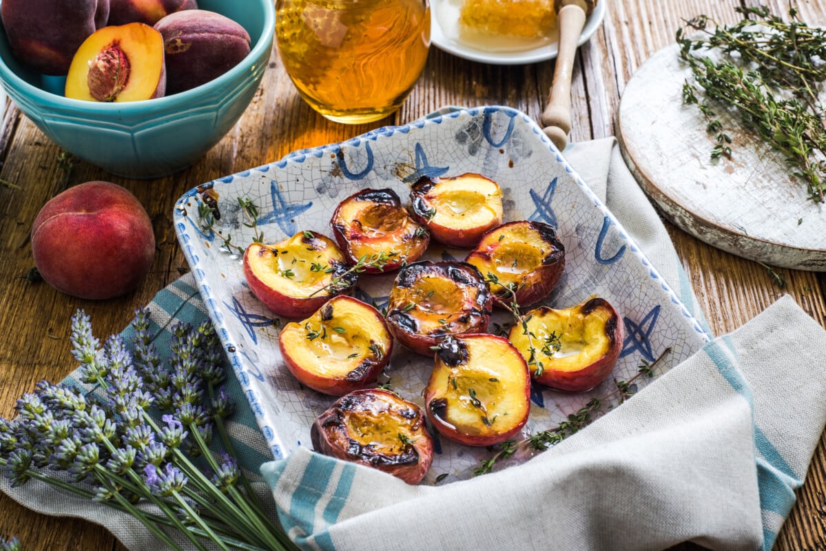 Baked peaches with honey and thyme in vintage tray