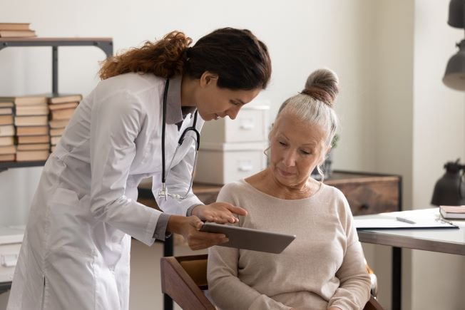 Female doctor sharing paperwork with patient