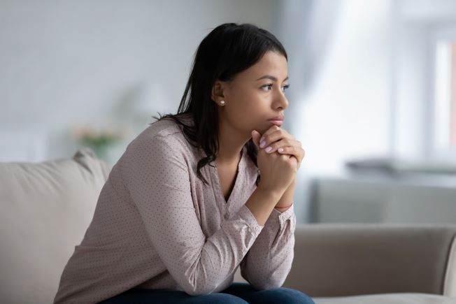 Woman sitting alone in deep thought