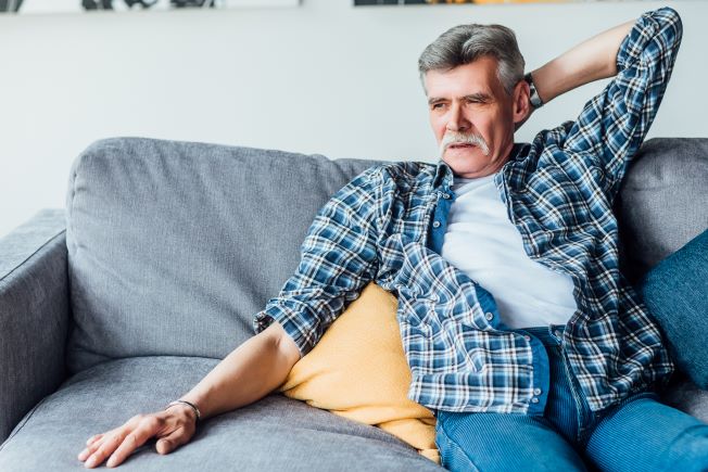 Man sitting alone looking anxious