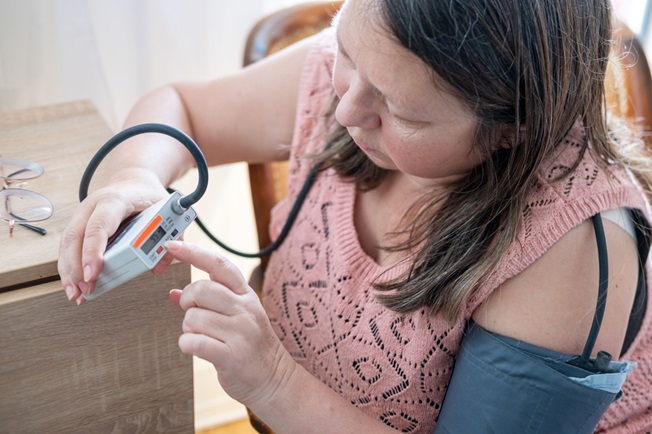 Woman at home taking vital sign reading