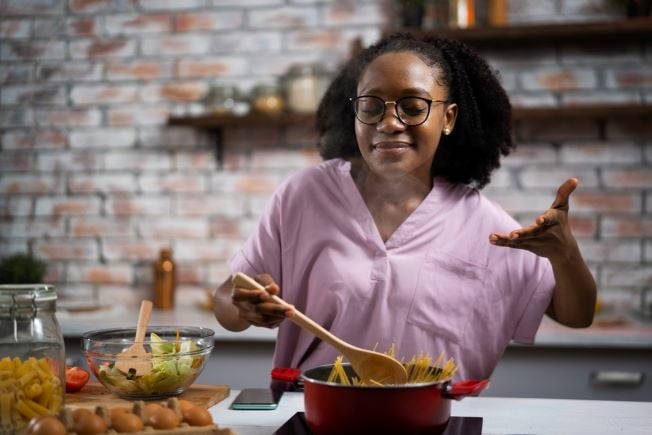 Woman in the kitchen cooking pasta