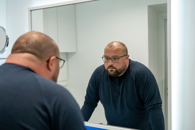 Man looking at himself in mirror