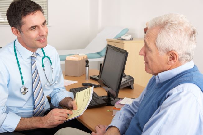 Older man talking with primary care doctor