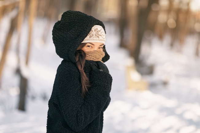 Woman in winter air all bundled up