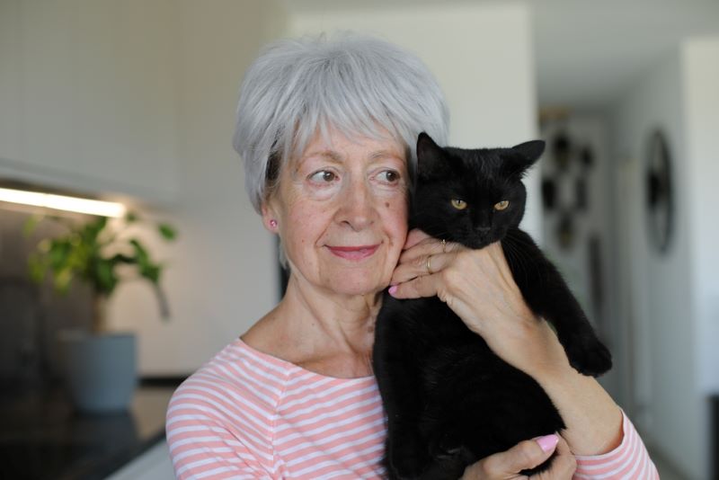 Woman in her 60s with a cat
