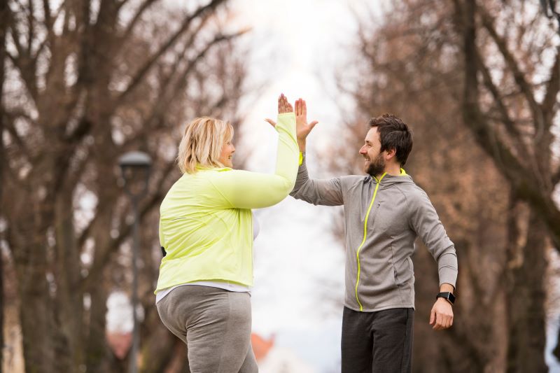 Woman running with a trainer