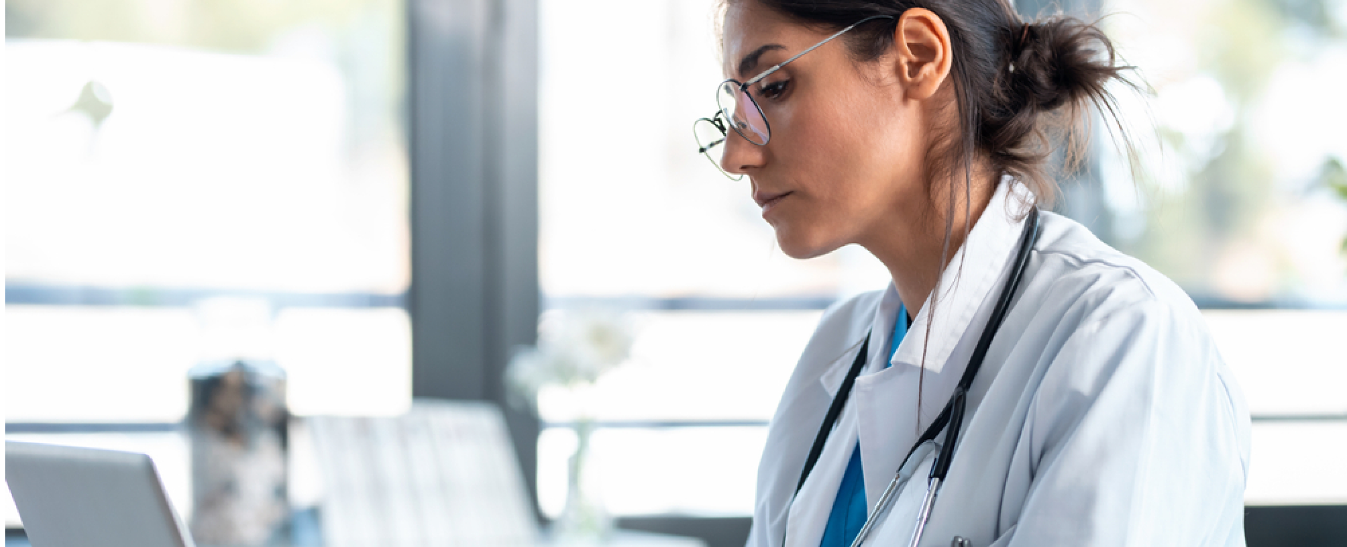 Physician doing computer work at desk