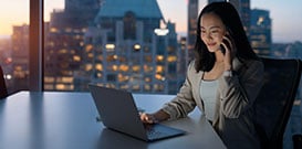Woman in her office speaking on her phone