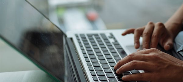 Woman typing on a laptop