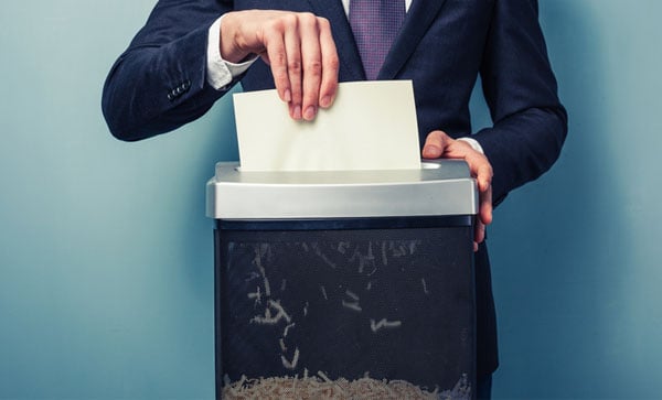 Secure Shredding Why shredding is important to your organization -man doing shreddign | Iron Mountain