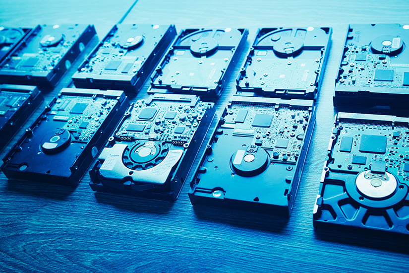 Several cartridge tape drives are lined up for secure data erasure, showcasing Iron Mountain’s data centre decommissioning services that ensure safe recycling and asset disposal.