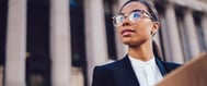 woman lawyer holding folder outside court