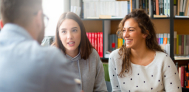 student and parent talking to teacher
