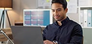Man in dark blue shirt working on the laptop providing financial services