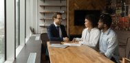 financial advisor helping out young couple