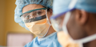 a healthcare professional in scrubs looking at colleague
