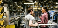 Mechanic and engineer talking in a factory