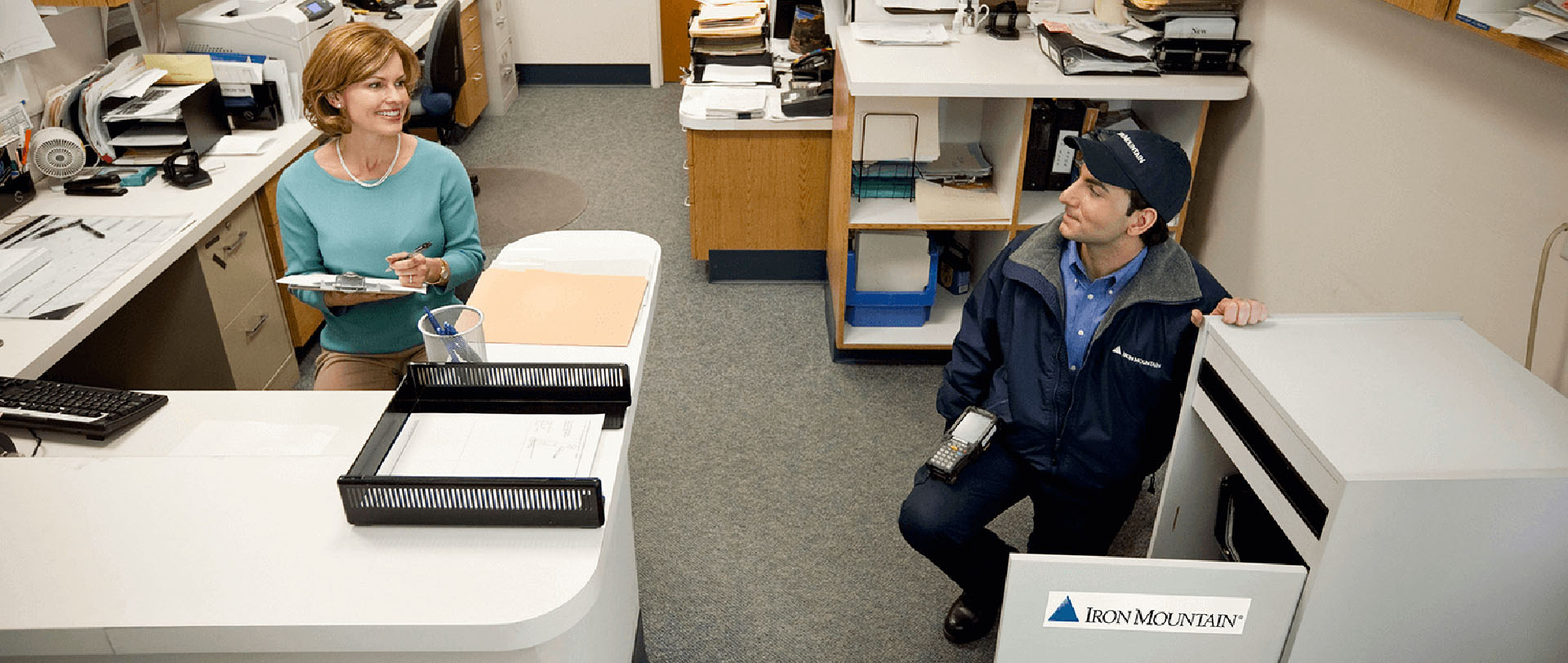 IM employee facilitating on-site paper shredding